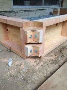 Detail of my forms. The corners are bolted together with braces that pull everything tight and square, and make disassembly very easy. Too bad I won't be using these again.