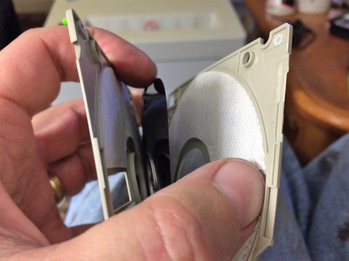 Pop open the plastic cover and retrieve the magnetic film.